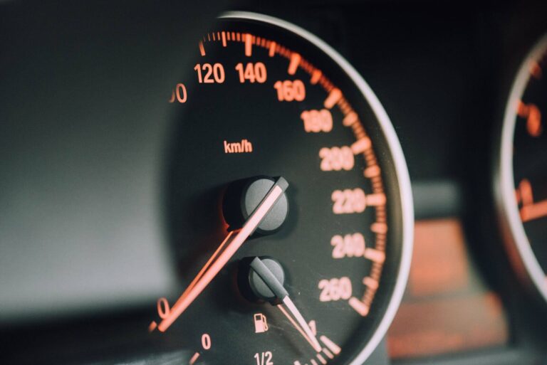 A closeup photo of a car’s fuel and speed gauges.