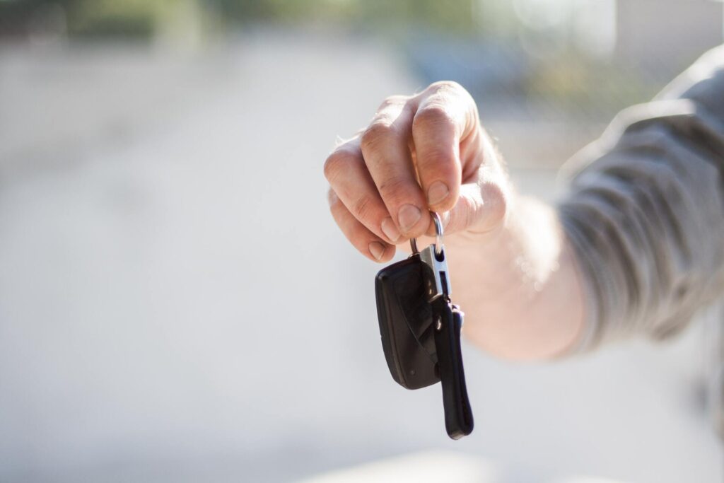 Person handing rental car key